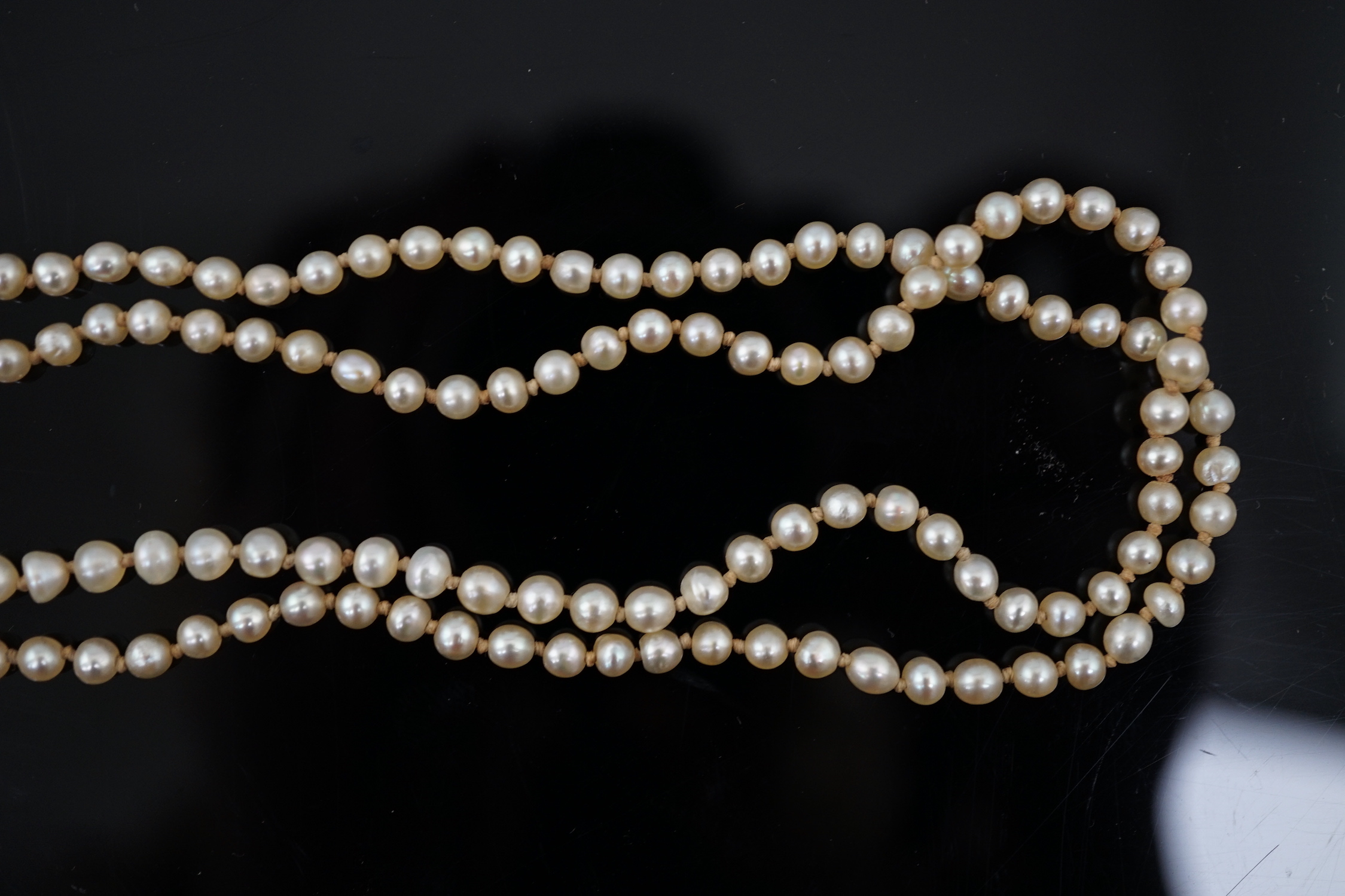A Victorian single strand graduated natural saltwater pearl necklace, with seed pearl and enamel set gold clasp